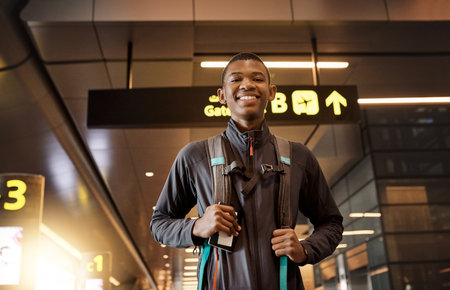 Eager to get going. Cropped portrait of a handsome young man standing in an airport.の写真素材