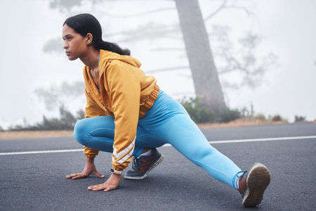 Outdoor fitness leg stretching, woman and runner exercise on a road in the mountains with focus....