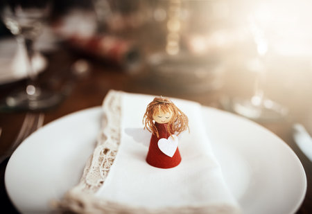 Theres a place for everyone at this table, even angels. Closeup shot of a place setting on a table at Christmas.の写真素材