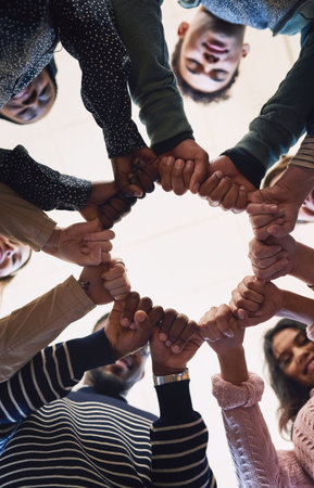 Our inner circle of friends. Low angle portrait of a group of young friends standing in a huddle.の写真素材