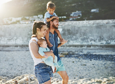 The beach is where we love to be. a young family spending quality time at the beach.の写真素材