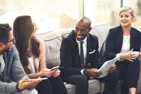 We sure do come up with the best ideas. a group of businesspeople brainstorming together in an office.の写真素材