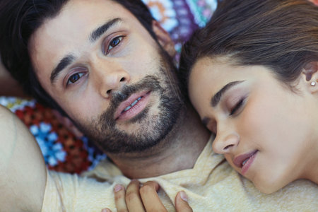 Keep your loved ones close to your heart. High angle portrait of a happy young couple relaxing on a blanket outside.の写真素材