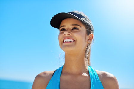 The beach is the perfect place for a workout. a sporty young woman out on the beach for her workout.の写真素材