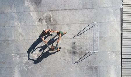 Soccer, team and high five, sport and fitness, celebrate or motivation with support, soccer player and teamwork in urban space. Athlete celebrating, practice and workout, training overhead and goal.の写真素材