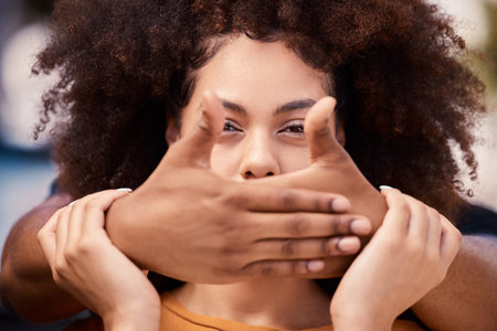 Woman, silence and victim hand cover mouth for stop, quiet and domestic violence secret. Fear, rape and black woman suffering from horror, gender based violence and sexual abuse, stuck and hostageの写真素材