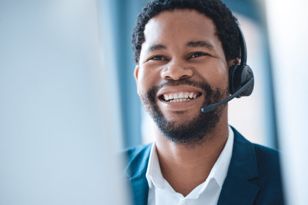 Customer support, black man and call center consultant speaking to an online client with a headset. Customer service, receptionist and telemarketing sales man consulting with technology in the officeの写真素材