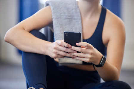 Fitness, smartphone or relax body of woman typing, scroll or browse health app, wellness blog post or social media gym feed. Girl hands of digital mobile user search web for training workout exerciseの写真素材