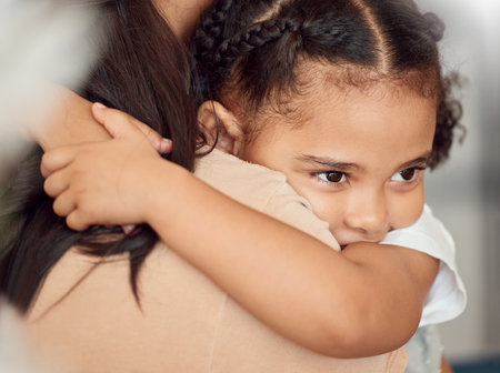 Child girl, hug and protection for holding mother, doing embrace and being sad. Black mother, nanny and daughter have quality time, safety and fear being moody, grief and disappointed with consoling.の写真素材