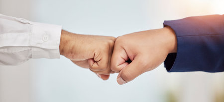 Business people, hands and fist bump in teamwork agreement for good job, winning or success at...
