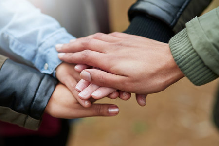 Making a pact to stay friends forever. Closeup shot of a group of friends with their hands together in unity.の写真素材