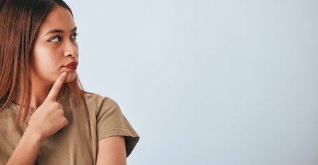 Thinking, woman and space for idea in studio with .advertising or product placement mockup. Face of...