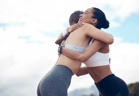 Fitness, friends and hug for sports exercise, workout and training for healthy lifestyle in nature. Happy active women hugging for sport friendship in cardio, health and wellness in the outdoorsの写真素材