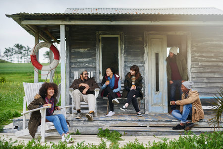 We decided to get lost for the weekend. a group of friends relaxing on the porch of a fishing cabin...