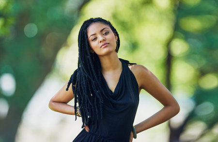 Style thats simple yet stand out. Portrait of an attractive young woman posing outdoors.の写真素材