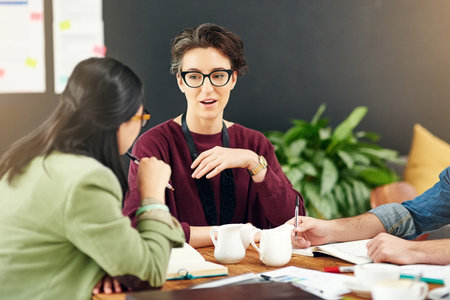You make a valuable point about that...a group of young creatives having a meeting in a modern office.の写真素材