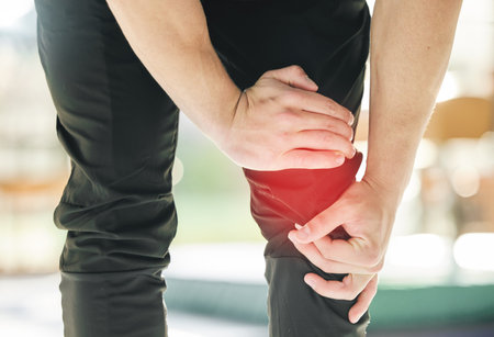 Hands, knee pain and injury in gym after accident, workout or training exercise for sports. Health, fitness and athlete man with fibromyalgia, inflammation or leg fracture, arthritis or tendinitis.の写真素材