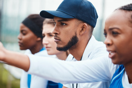 Sports, people and group of man and women watching a match together at a field, focus and concentration. Diversity, team and athletes relax during training, game and performance at outdoor courtの写真素材