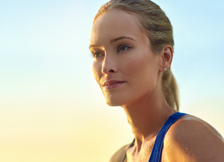 Always look forward. a sporty young woman standing outdoors.の写真素材