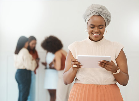 Tablet, business woman and reading online with a smile for communication, internet and network. Happy black female entrepreneur working on touch screen for social media, leadership report or searchの写真素材