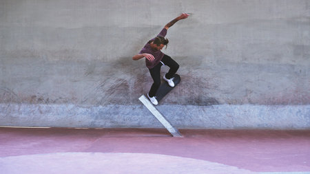 Stop thinking and start doing. a young man doing tricks on his skateboard at the skatepark.の写真素材