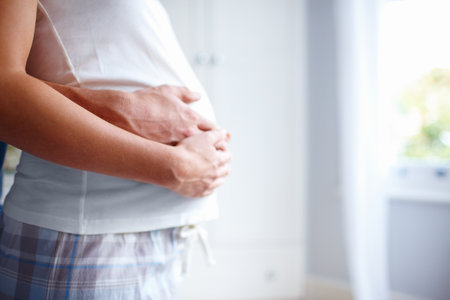 Protection and guidance - Expectant parents. Cropped image of a loving husband holding his wifes baby bump - Copyspace.の写真素材