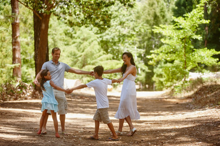The best part about memories is making them. a happy family spending quality time together in the forest.の写真素材