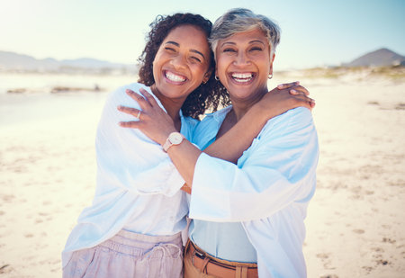 Portrait, family and mother with adult daughter hug, happy and bond at beach together, smile and relax. Love, parent and girl embrace, travel and excited for ocean trip, holiday and freedom in Miamiの写真素材