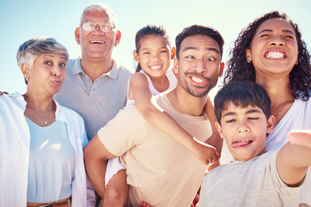 Big family, crazy portrait of grandparents and kids with mom, dad and smile, happy bonding together on ocean vacation. Sun, fun and happiness for generations of men and women with children on holidayの写真素材