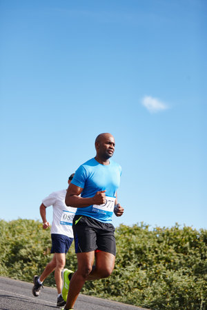 The marathon mindset- anything is possible. a young man running a marathon.の写真素材