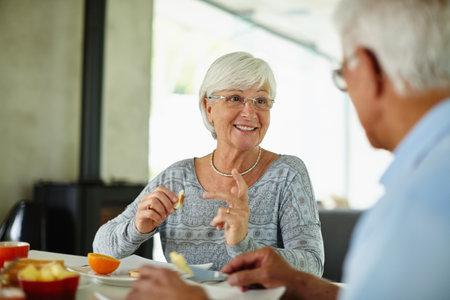 All happiness depends on a healthy breakfast. a senior couple having breakfast at home.の写真素材
