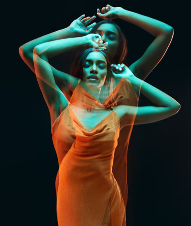Green light, double exposure and dancing of woman with beauty and art aesthetic. Creative neon lighting, female and model with dark background in a studio with modern style and designer dressの写真素材