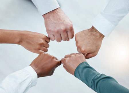 Teamwork, fist bump and hands of business people together for motivation, support and community. Collaboration, team building and top view of employees in circle for diversity, solidarity and goalsの写真素材