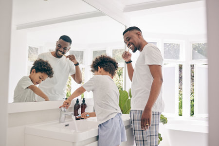 Brushing teeth, father smile and healthy morning routine in a bathroom sink with a dad and child. Hygiene, kid and dada together in a house with toothbrush and youth doing self care for dentalの写真素材