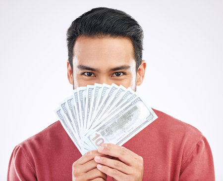Money fan, cash and portrait of man on white background for investment, financial savings and payment. Finance profit, winner and isolated male for winning, prize and stock market success in studioの写真素材