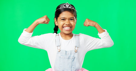 Strong, muscle flex and girl on green screen with flexing arms pose for growth, empowerment and happy. Strength mockup, smile and portrait of excited girl in studio for power, confidence and bicepsの写真素材