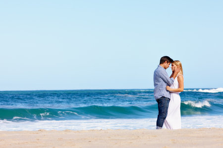 You make this vacation perfect. a happy young couple enjoying a romantic day on the beach.の写真素材