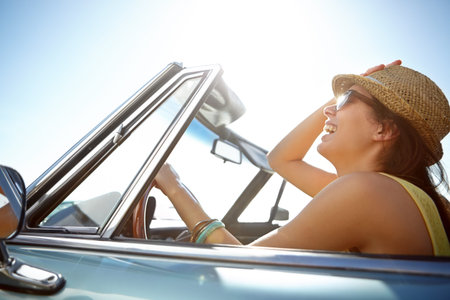 Woman, road trip and smile for summer journey, freedom or travel vacation in the sunny outdoors....