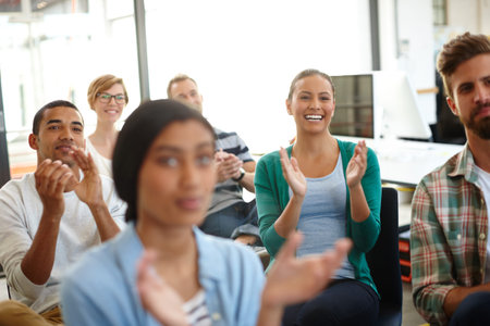 That was really insightful. a group of young designers applauding a work presentation.