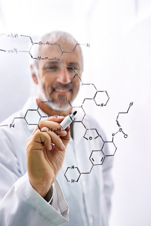 Passionate about chemistry. a mature male scientist working with chemistry formulas in his lab.の写真素材