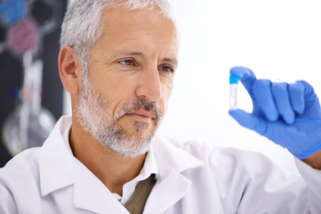 Hes so close to a breakthrough. a mature male scientist looking at a medical sample in his lab.の写真素材