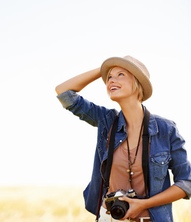 Fascinated by nature. an attractive young woman outdoors on a summer day.の写真素材