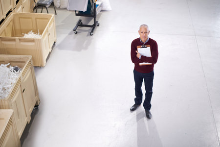 Inspections are done at regular intervals. Portrait of a factory manager standing with a clipboard.の写真素材