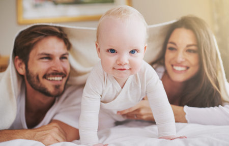 My parents and me. a young couple and their baby daughter in the bedroom.