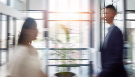 Motion blur, business and people in office, moving and fast speed with deadline, schedule and consultants. Employees, coworkers and agents in workplace, busy and walking for new project and agencyの写真素材