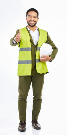 Portrait, Asian man and architect with thumbs up, happy and agreement on a white studio background....