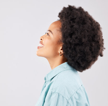 Black woman, profile and happiness smile in a studio thinking and feeling relax. Isolated, white background and happy young model with youth and natural afro with female empowerment and ideaの写真素材