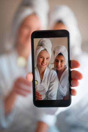 Woman, friends and portrait selfie in beauty spa for relaxation, skincare or facial treatment at resort. Happy women smiling for profile picture, photo or vlog in zen, body care or wellness at salonの写真素材