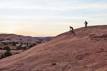 Life is too short not to go mountain biking. Full length shot of two men out mountain biking together during the day.の写真素材
