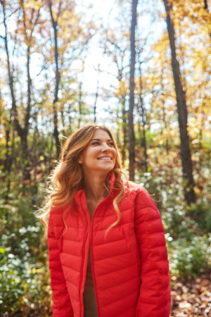 Autumn is beautiful when you take it all in. an attractive young woman in the forest during autumn.の写真素材